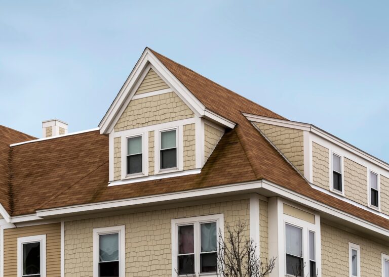 Roofing Lino Lakes Dormer windows on the sloped shingle roof of a newly built house