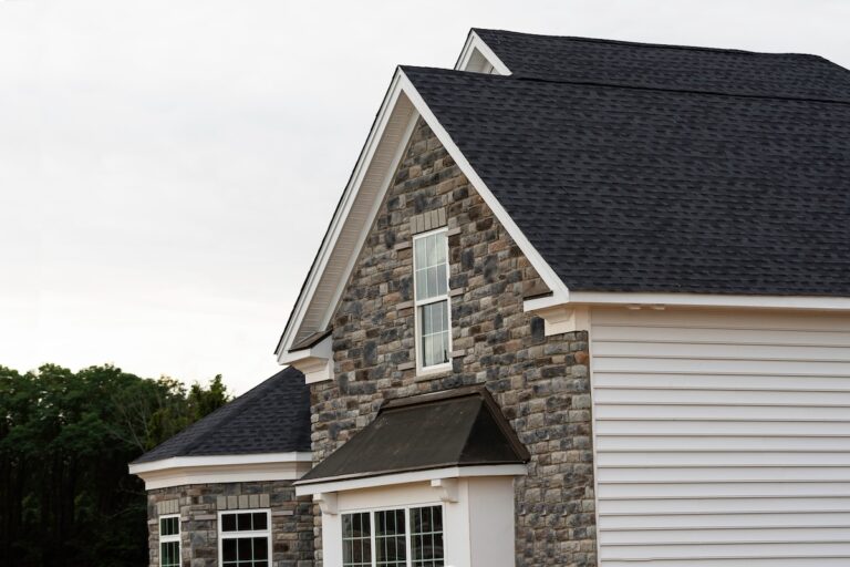 Roofing White Bear Lake edge of roof shingles on top of the house dark asphalt tiles on the roof background color