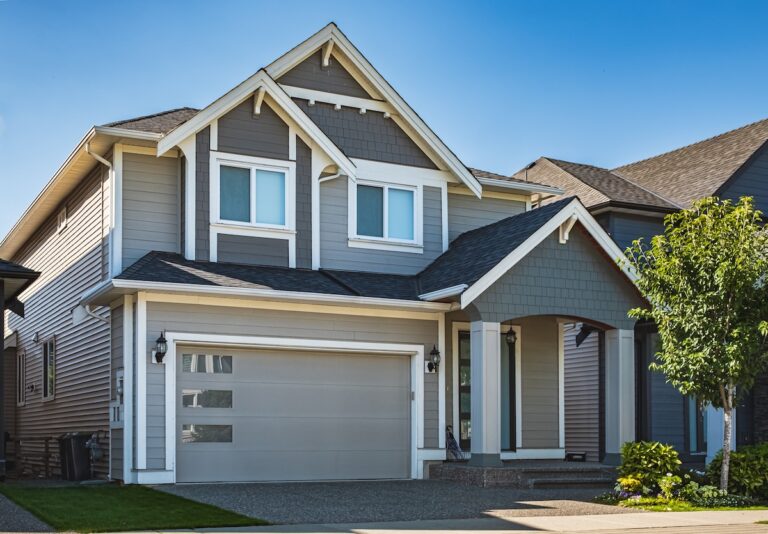 Roofing White Bear Lake Real Estate Exterior Front House on a sunny day. Big custom made luxury house with nicely landscaped front yard and driveway to garage in suburbs. Modern designed home, New construction home exterior