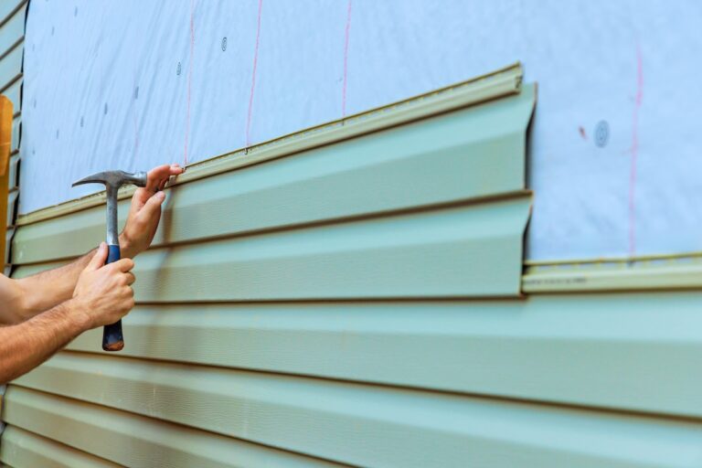 Contractor is installing new siding on house