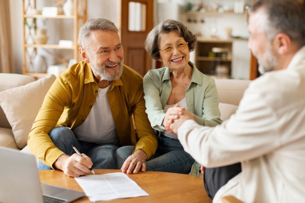 Happy senior couple of clients meeting with contractor