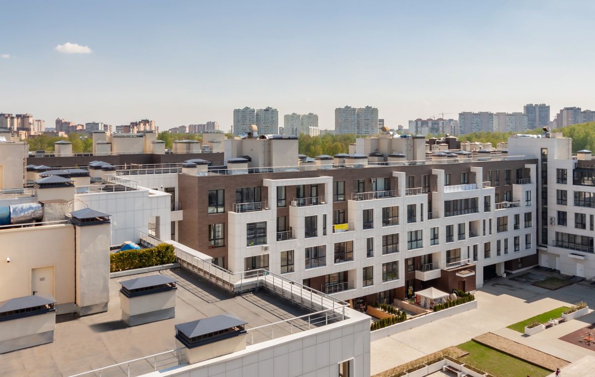 apartment complex with park and flat roofs