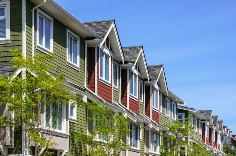 colorful apartment buildings with dark grey shingle roofs