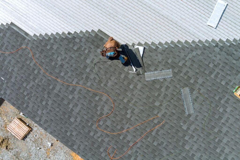 roofer installing shingles on a roof