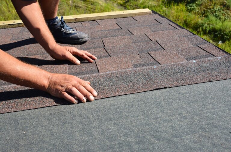 Roofing contractor lay asphalt shingles tiles on house rooftop. Asphalt shingles roofing construction, repair, installation, replace