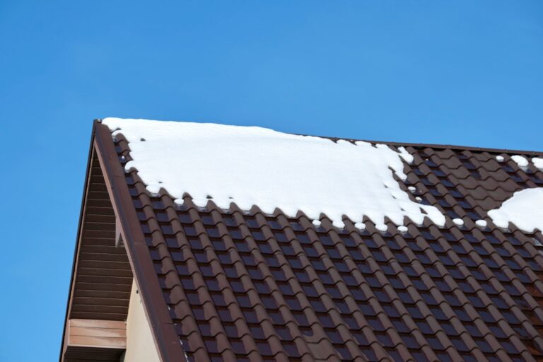 Closeup of house roof top covered with snow in cold winter