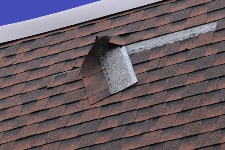 Damaged Brown Roof Shingle - Wind Damage