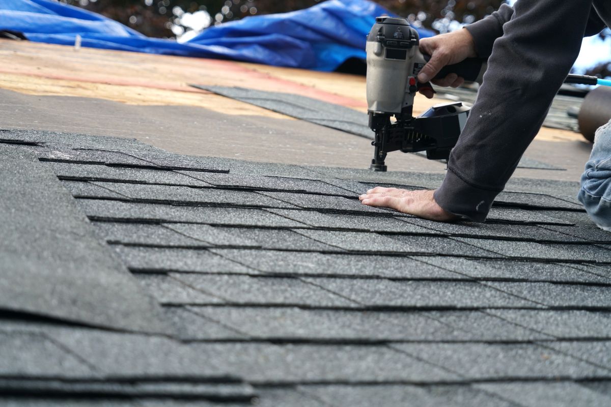 roofer using nail gun