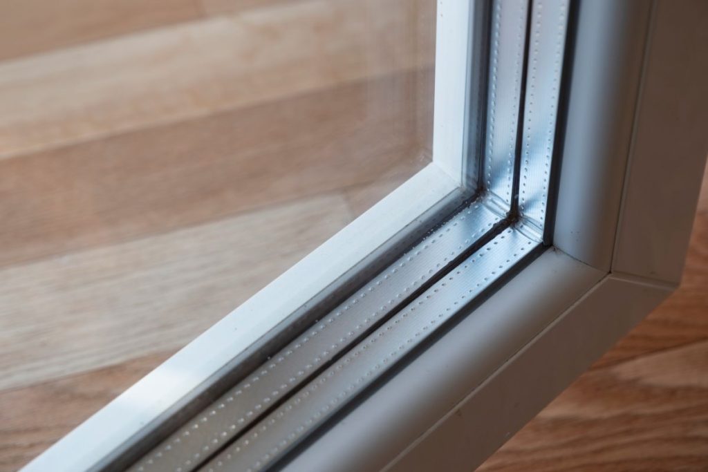 Detail of a window frame with triple glazing