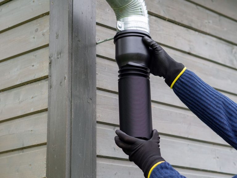 Flexible plastic rain gutter pipe installation. Rainwater collection for garden watering. Gutter extension for homes