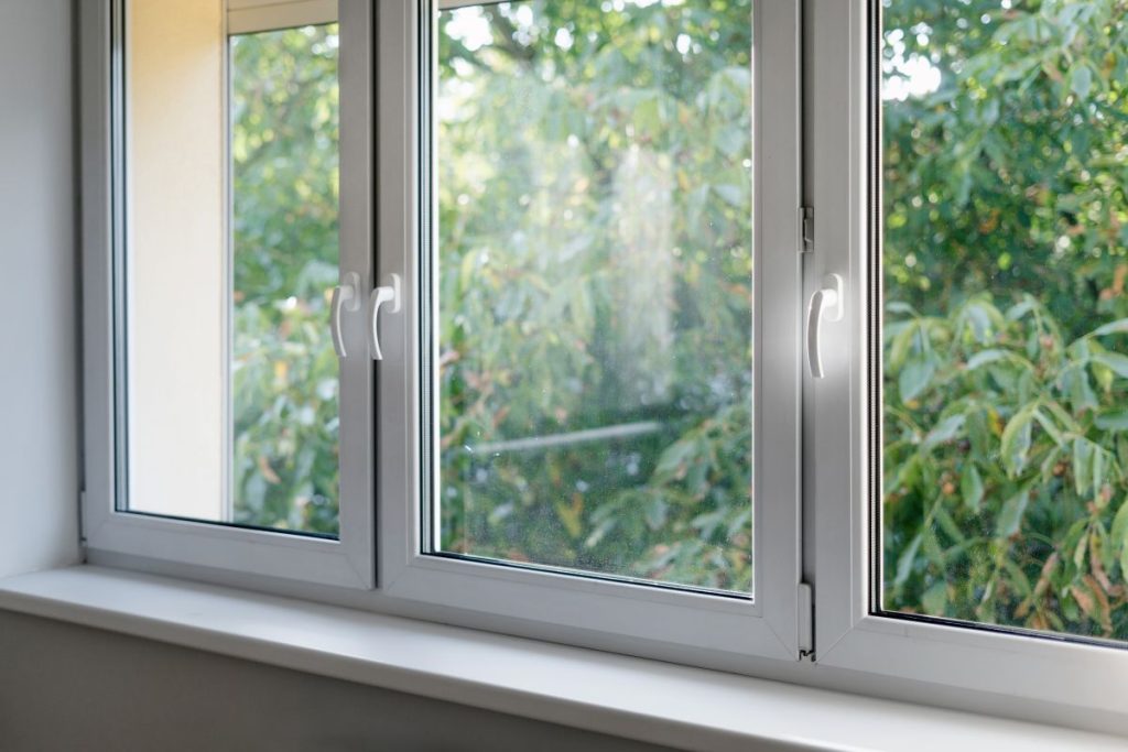 White window frame with modern aluminium profiles in bedroom